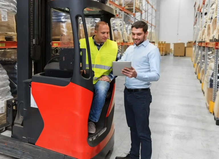 Forklift and businessman with tablet