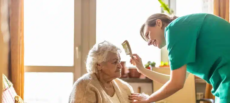 Female nurse taking care of a senior woman at home